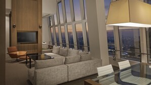 A modern living room with a sofa, a glass table, and a TV mounted on the wall. - Park Hyatt Shanghai (Shanghai)