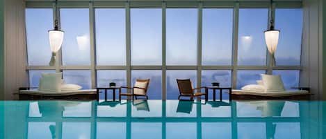 Indoor pool, open 7:00 AM to 10:00 PM, pool loungers, lifeguards on site