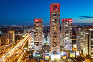 A cityscape at night with illuminated skyscrapers, including buildings with 'PICC' and 'YINTAI' signage. - Park Hyatt Beijing (Beijing)