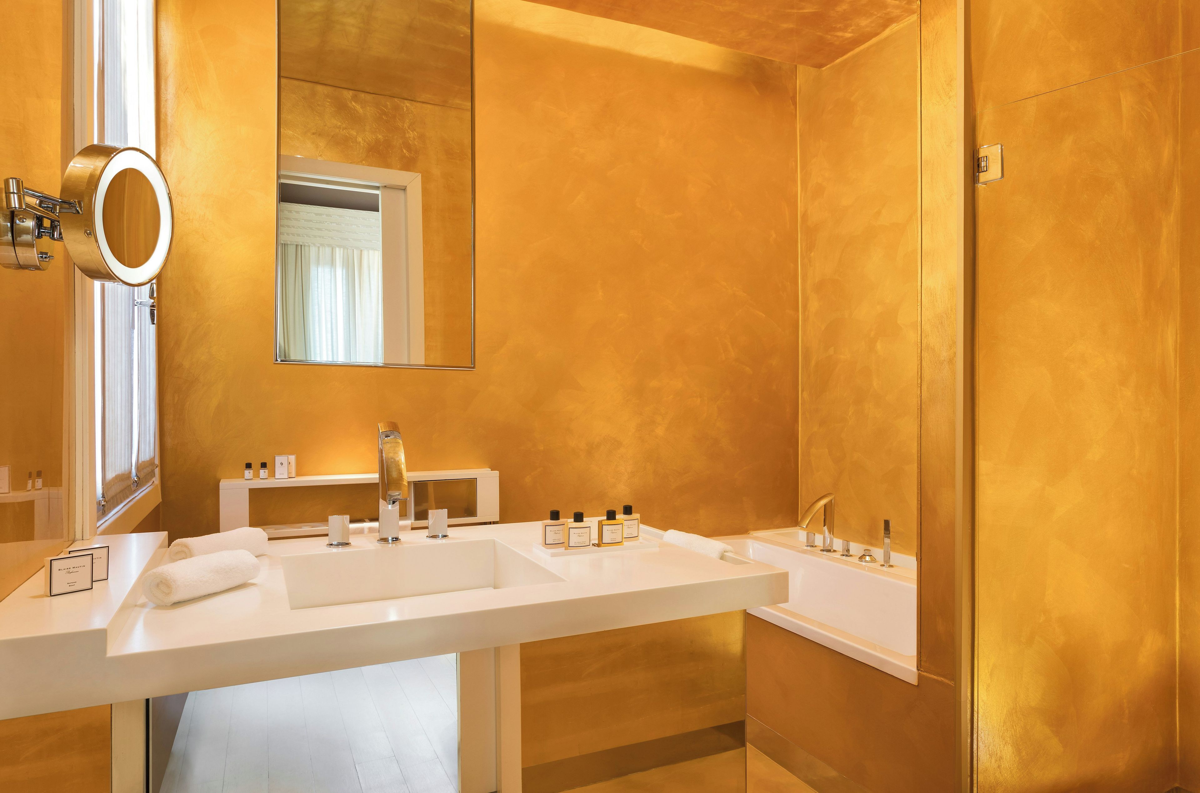 A modern bathroom with two sinks, a mirror, and a shower.