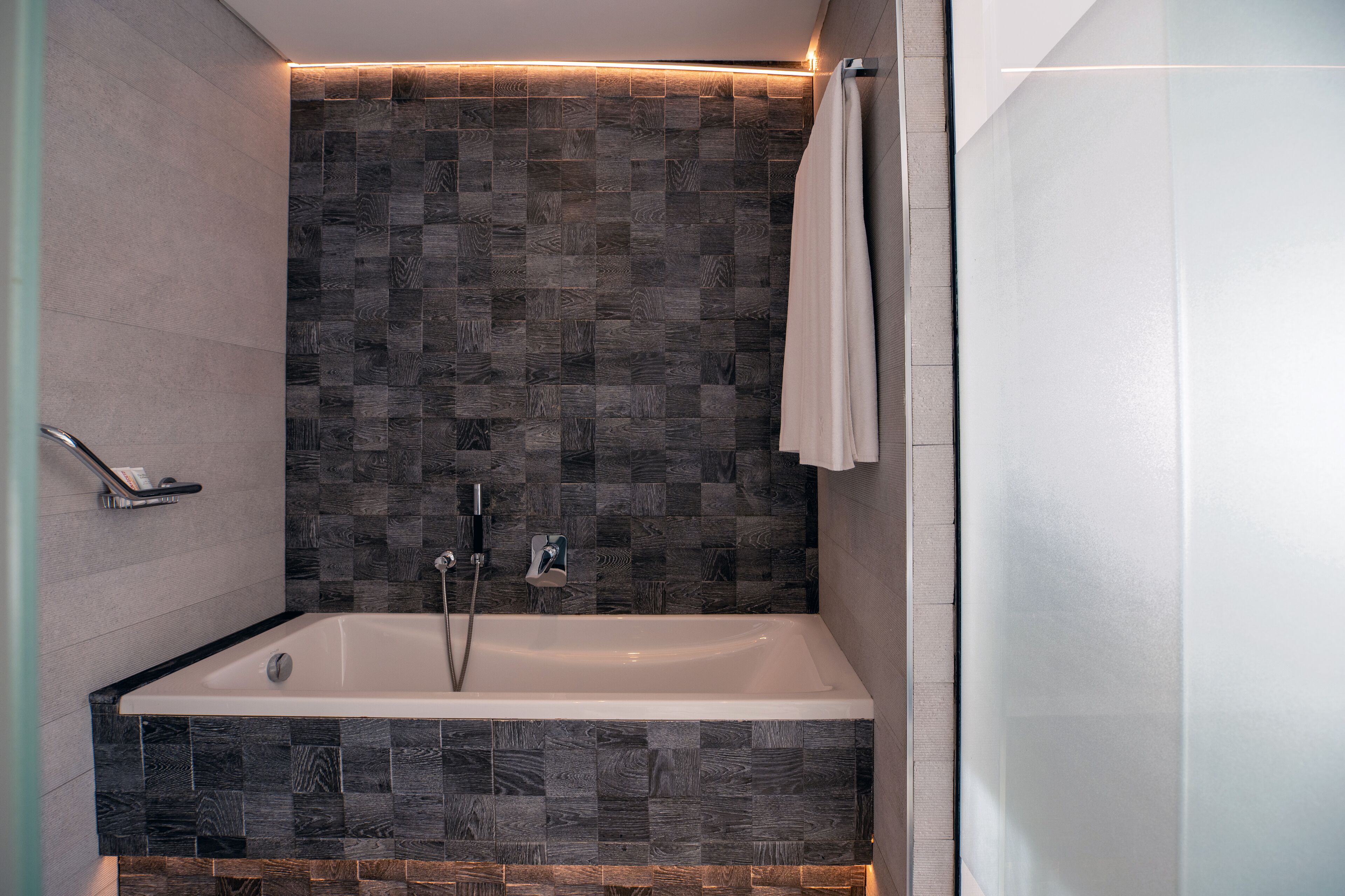 A modern bathroom with a freestanding bathtub, a shower area, and a glass shower enclosure.
