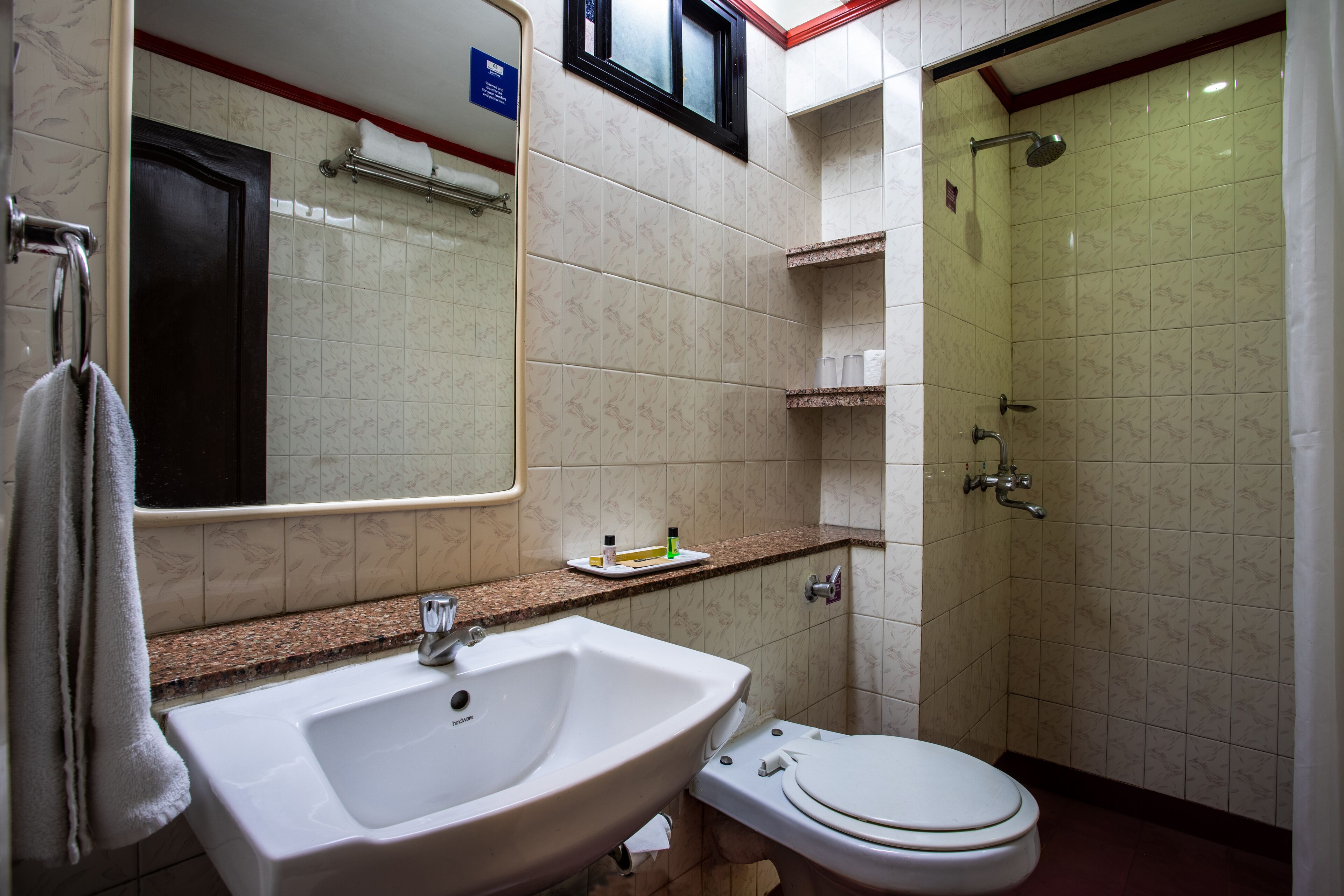 A bathroom with a sink, toilet, and shower.