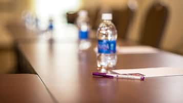 A conference table with a water bottle and a pen.