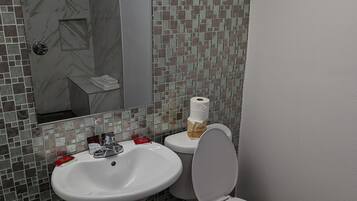 A bathroom with a white sink, a toilet, and a mirror.