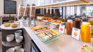A buffet with various food items and a sign that reads "Laughter is brightest where the food is good." - JetPark Hotel Rotorua (Rotorua)
