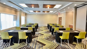 A conference room with tables and chairs, a patterned carpet, and a ceiling with recessed lighting. - Holiday Inn Express Hotel & Suites Mobile/Saraland by IHG (Saraland)
