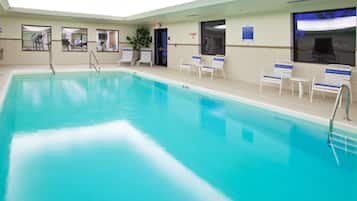 Relax by the rectangular pool surrounded by comfortable lounge chairs.
