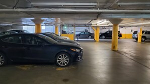 A multi-level parking garage with cars parked on different levels. - Royal Pacific Motor Inn (San Francisco)