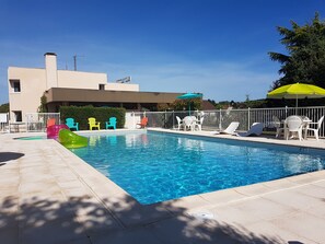 季节性开放的室外游泳池，池畔遮阳伞，日光浴躺椅