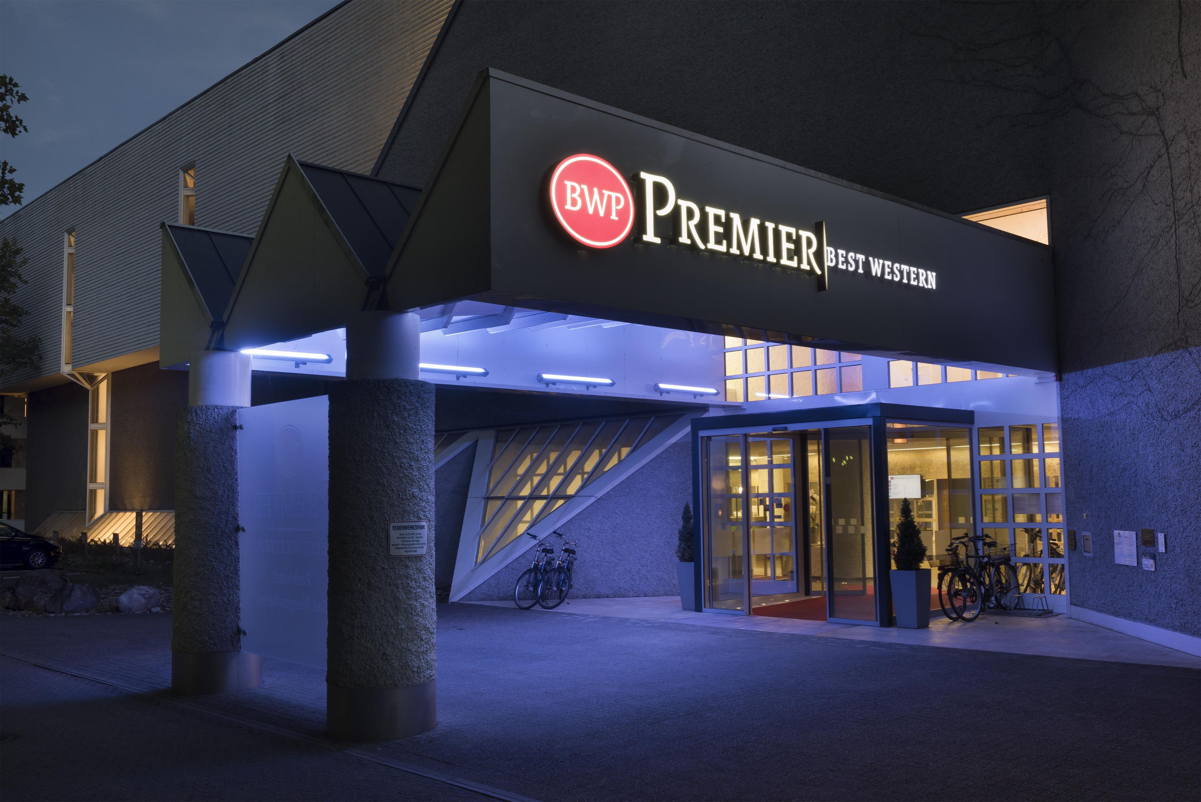 A hotel entrance with a prominent sign reading 'Premier Best Western.'
