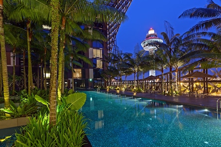 Outdoor pool, pool umbrellas, sun loungers. Crowne Plaza Changi Airport by IHG