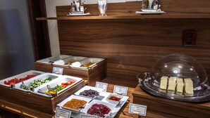 A buffet with various food items and condiments. - EA Hotel Downtown (Prague)