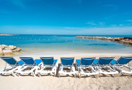 Private beach, white sand, sun loungers, beach umbrellas