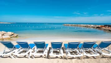 Private beach, white sand, sun loungers, beach umbrellas