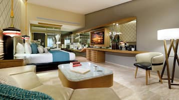 A modern hotel room with a large bed, a sitting area with a coffee table, a desk, and a large mirror.