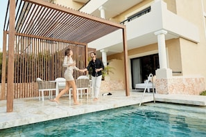 A poolside area with a wooden pergola, lounge chairs, and a clear view of the pool. - TRS Yucatan Hotel - Adults Only - All Inclusive (Kantenah)