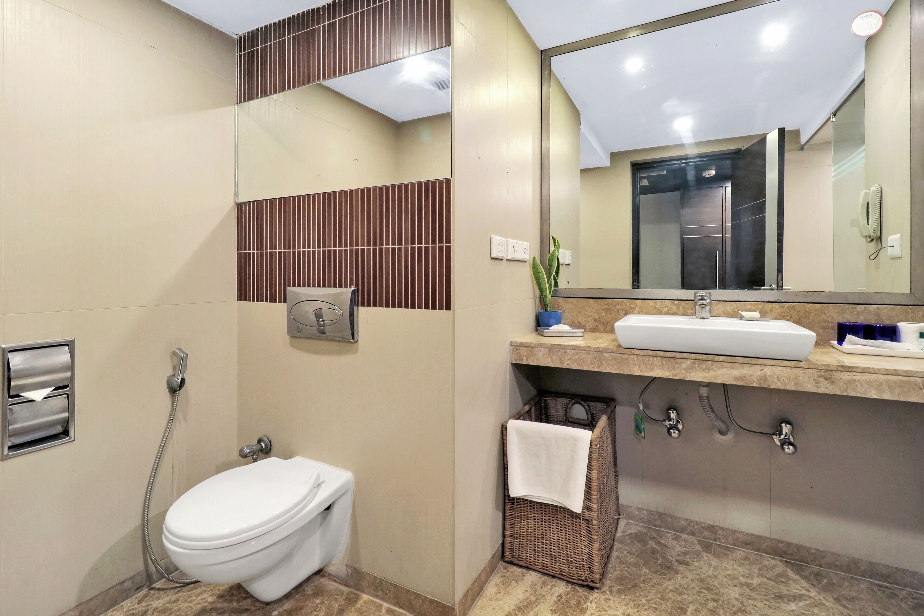 A modern bathroom with a toilet, sink, and shower.
