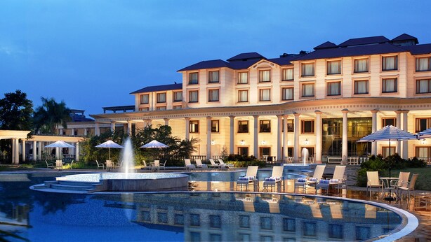A hotel with a large pool, outdoor seating, and a fountain. - Fortune Park Panchwati, Kolkata - Member ITC Hotels' Group (Howrah)