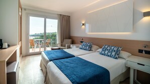 A hotel room with two beds, a desk, a chair, and a balcony with a view. - Hotel THB Felip - Adults Only (Manacor)