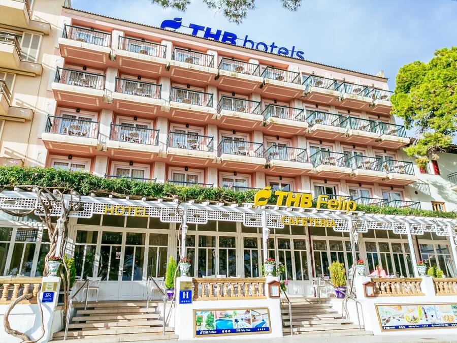 A multi-story hotel with balconies, a cafe, and a restaurant on the ground floor.