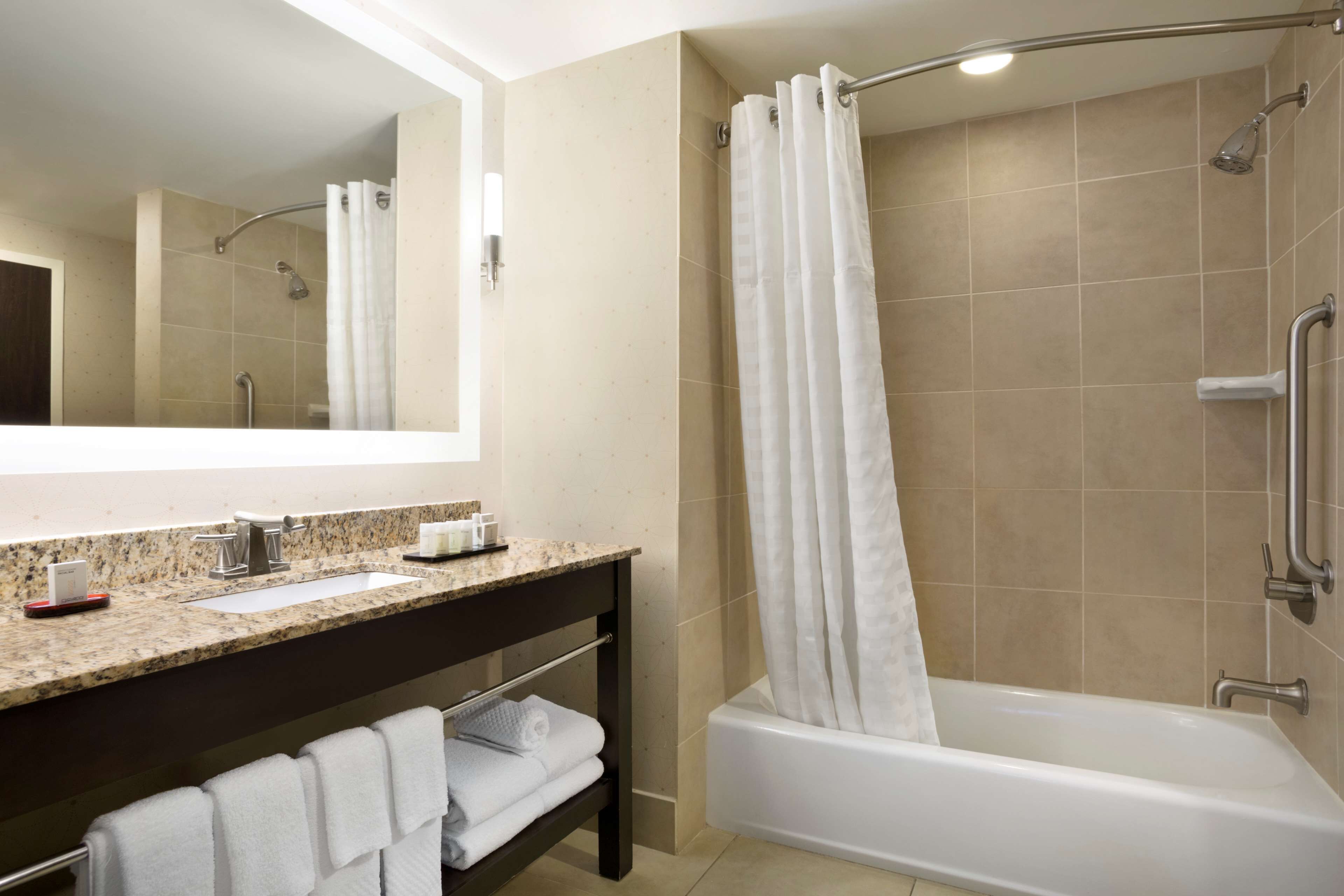 combined shower/bathtub, designer toiletries, hair dryer, towels