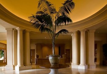 Experience the grandeur of our lobby, featuring a majestic palm tree and elegant columns. at The Resort at Pelican Hill