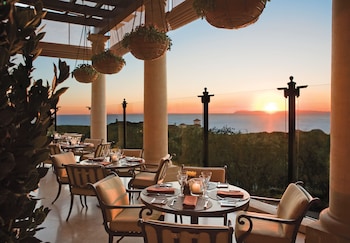 Enjoy al fresco dining amidst serene mountain views and tranquil ambiance. at The Resort at Pelican Hill