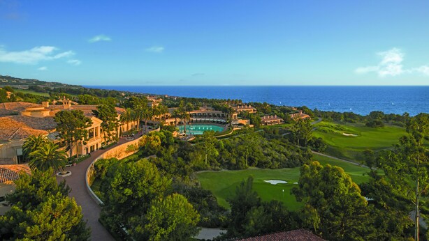 A resort with a swimming pool, golf course, and ocean view. - The Resort at Pelican Hill (Newport Beach)