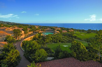 Enjoy breathtaking ocean views from this resort, surrounded by lush greenery and palm trees. at The Resort at Pelican Hill