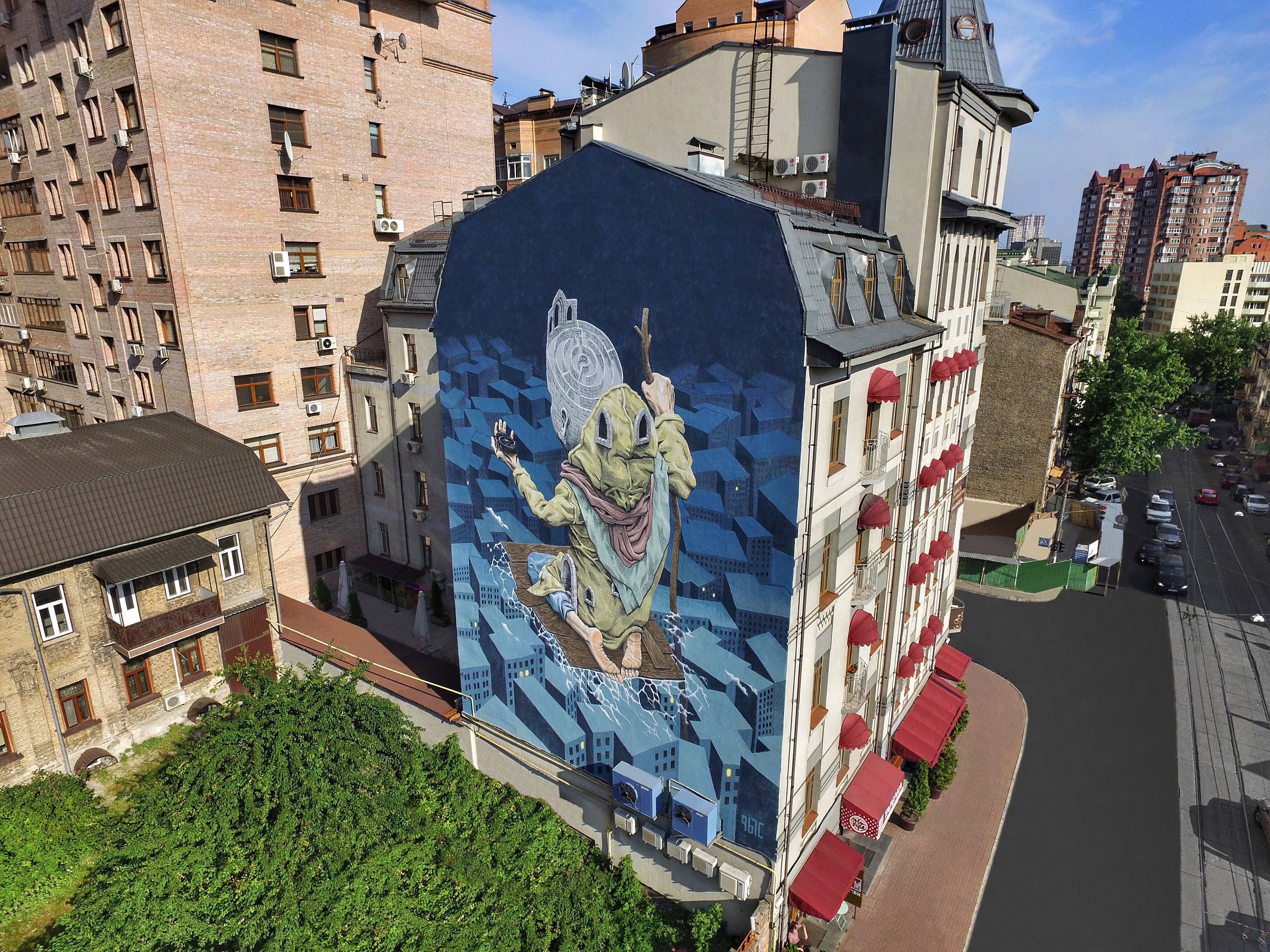 A multi-story building with a mural on the side.