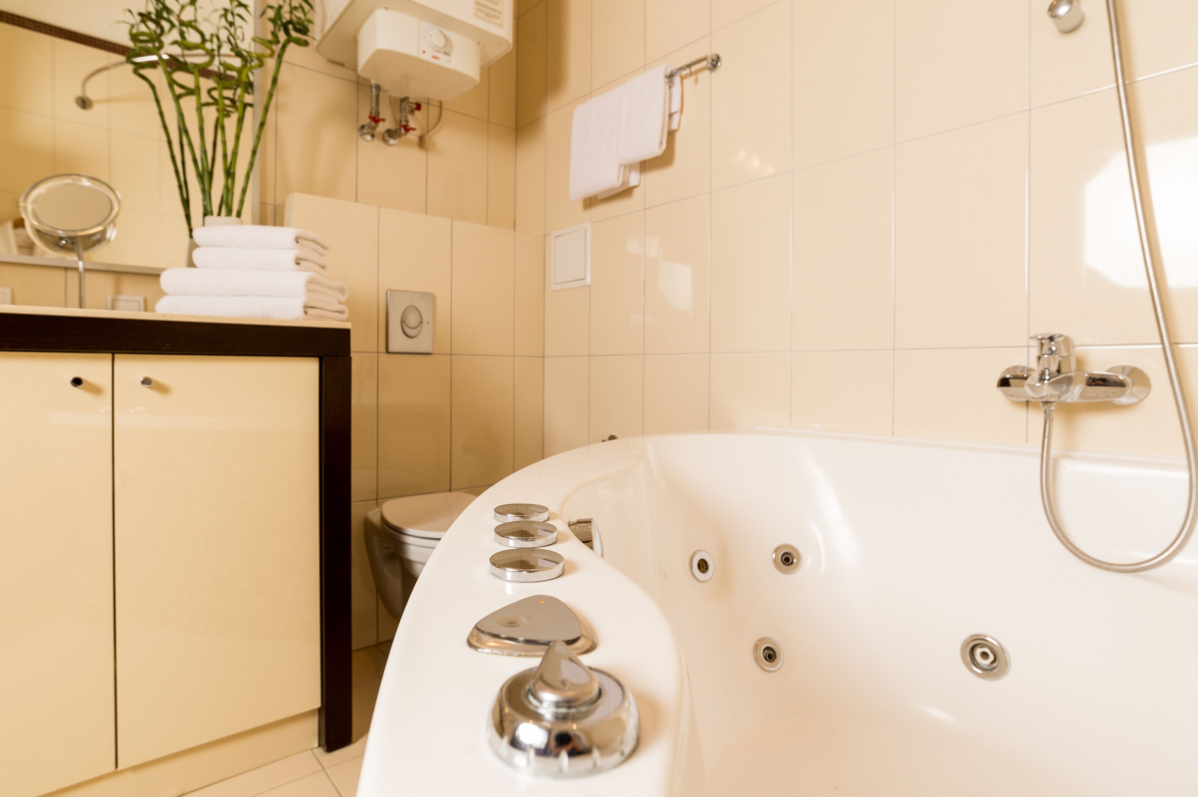 Een moderne badkamer met een groot bad, een wastafel met spiegel en een toilet.