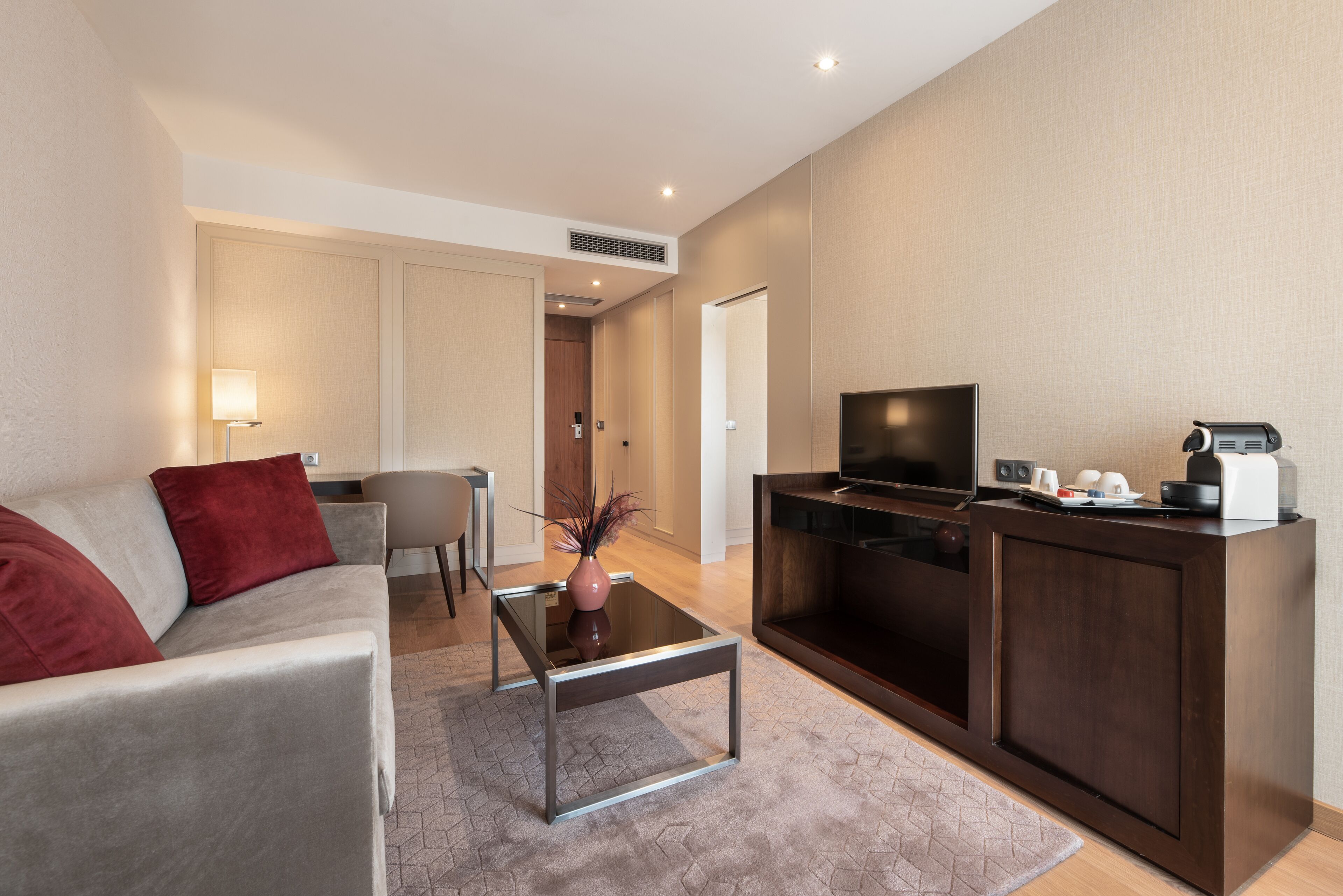 junior suite, 1 king bed with sofa bed | living area | flat-screen tv