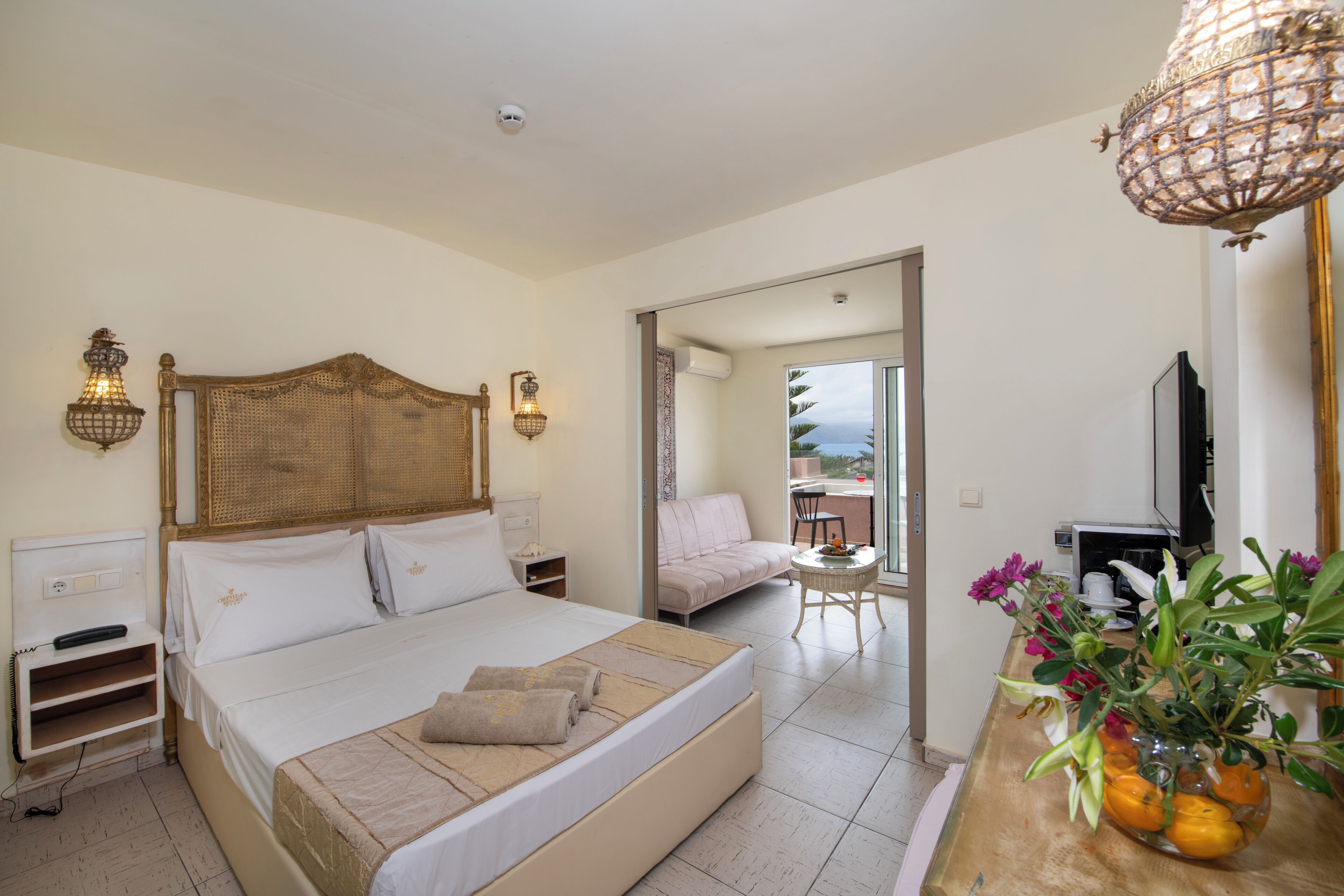 Una camera d'albergo con un letto grande, un comodino, una lampada, una televisione e vista all'esterno.