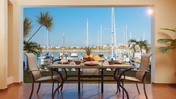 Enjoy meals with a view of the marina and sailboats from this dining area.