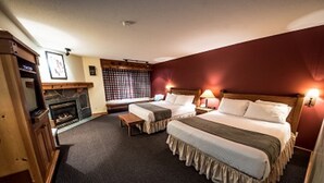 A hotel room with two beds, a fireplace, and a wooden cabinet. - White Crystal Inn (Beaverdell)