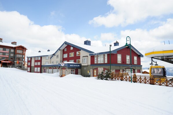 A snow-covered building with a ski lift and a sign for 'White Crystal Inn'. - White Crystal Inn (Beaverdell)