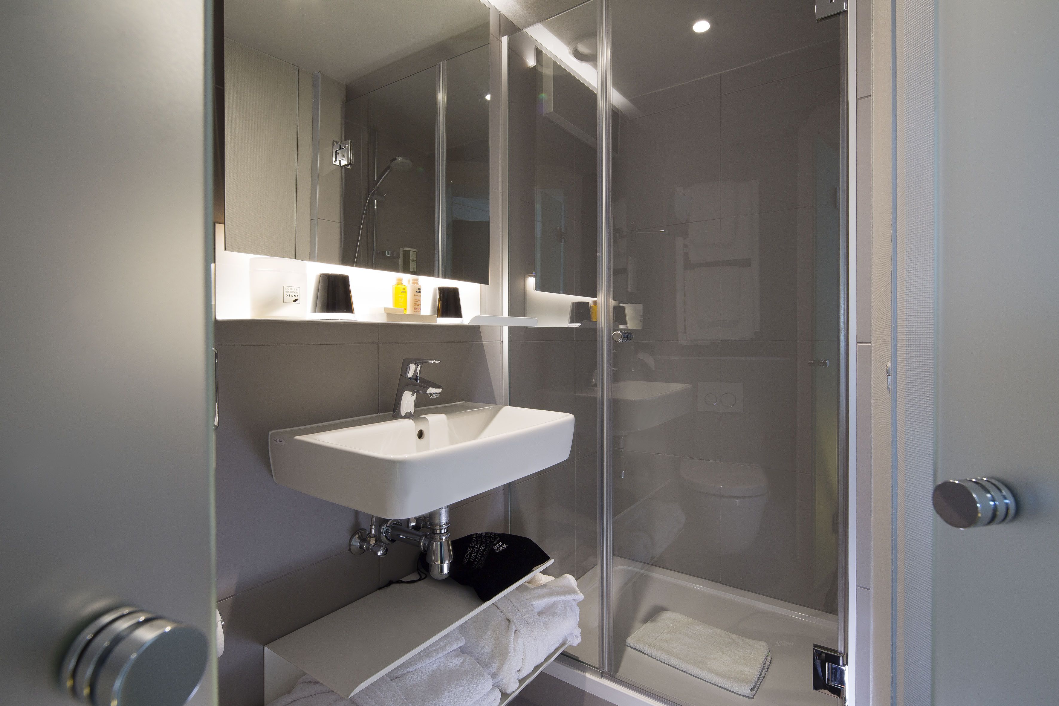 designer toiletries, hair dryer, bathrobes, slippers