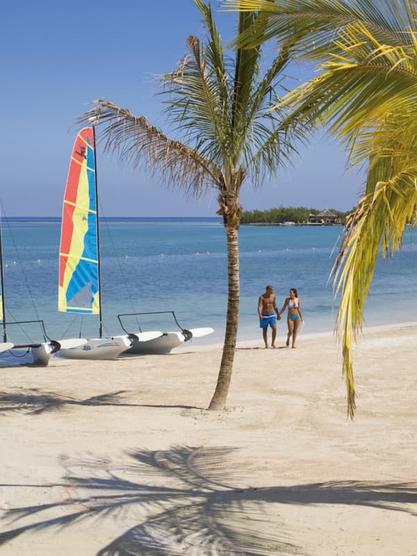 On the beach, white sand, sun loungers, beach towels