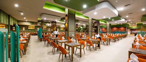 A spacious restaurant with multiple dining areas, each with tables and chairs.