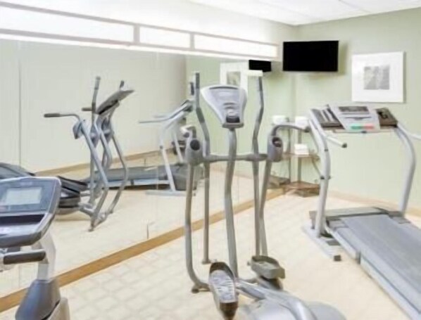 A gym with various exercise equipment including treadmills, elliptical machines, and stationary bikes. - Microtel Inn & Suites by Wyndham Saraland/North Mobile (Saraland)