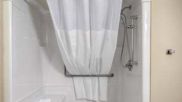A shower with a white curtain, a handheld showerhead, and a towel rack.