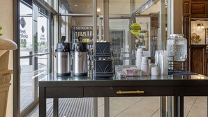 A coffee shop counter with a coffee machine, a hot water dispenser, and a coffee press. - Best Western Plus Fredericton Hotel & Suites (Fredericton)