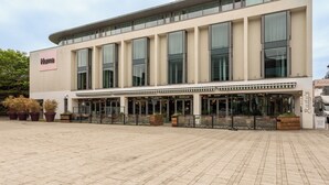 A modern building with a flat facade, large windows, and a sign reading "Numa". - Numa Brighton Pavilion (Brighton)