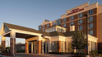 A Hilton Garden Inn with a covered entrance, brick facade, and multiple windows.