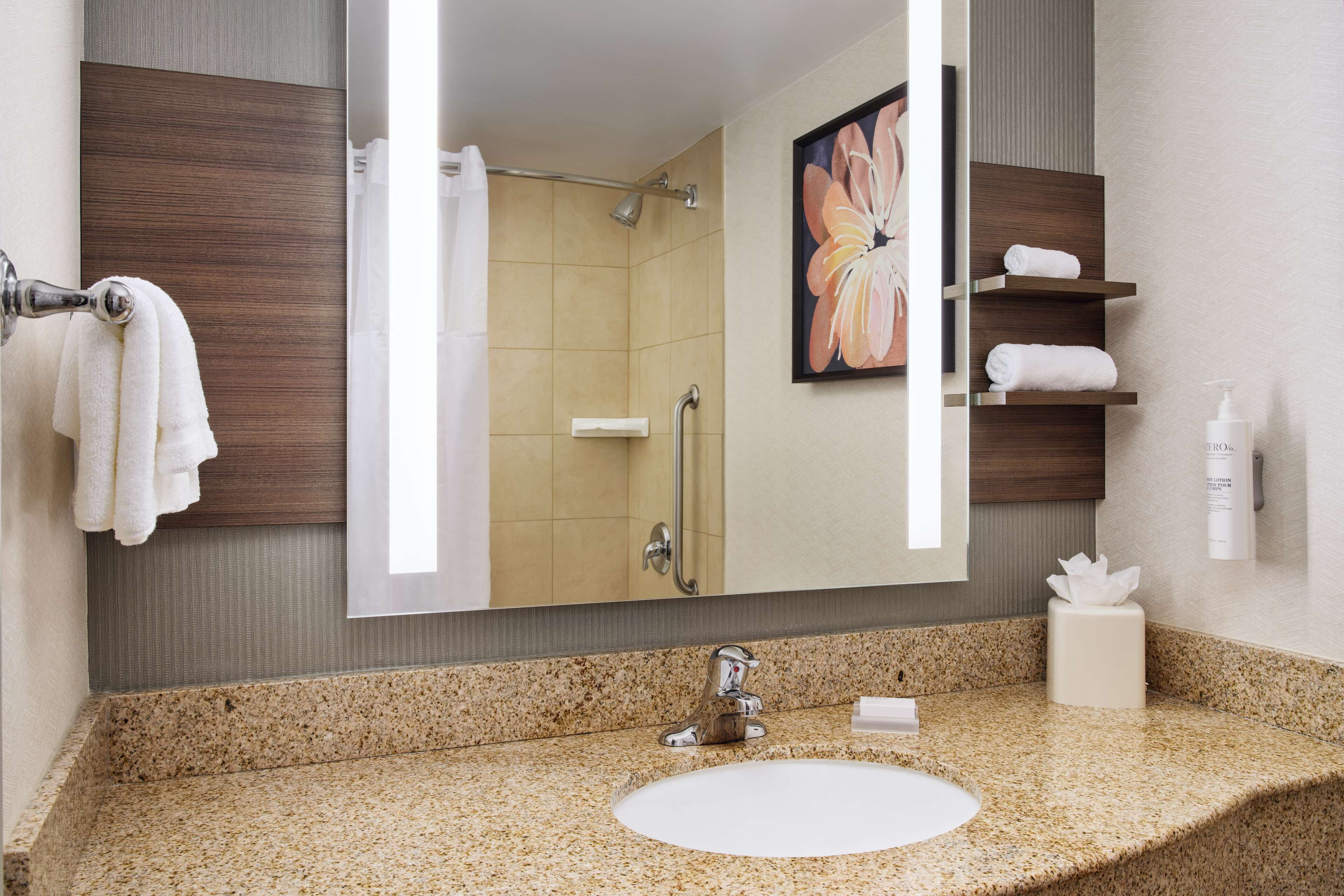 designer toiletries, hair dryer, towels, soap