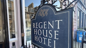 A sign for Regent House Hotel with a classic design and a black and white color scheme.