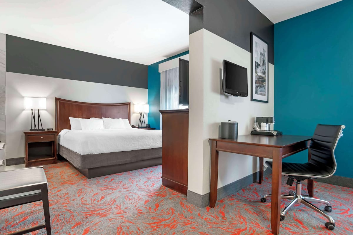 suite, 1 king bed, non smoking, jetted tub (with single sofabed) | desk, laptop workspace, blackout curtains, iron/ironing board