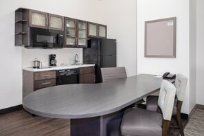 A compact kitchen with a microwave, coffee maker, and refrigerator. - Candlewood Suites Cheyenne by IHG (Cheyenne)