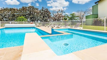 Seasonal outdoor pool, open 9:00 AM to 9:00 PM, pool loungers