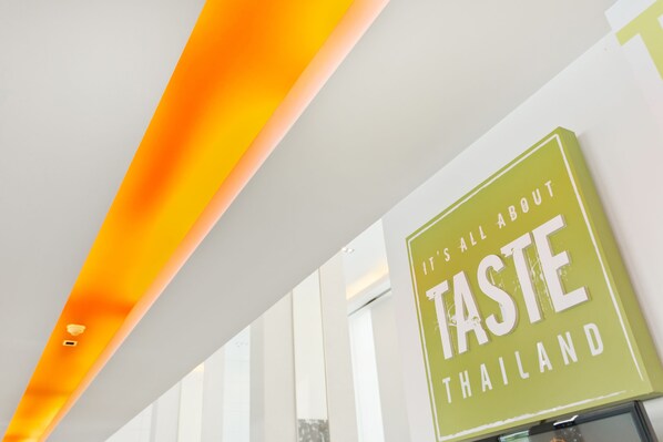 A sign with the text "It's all about TASTE Thailand" in a green box. - ibis Pattaya (Pattaya)